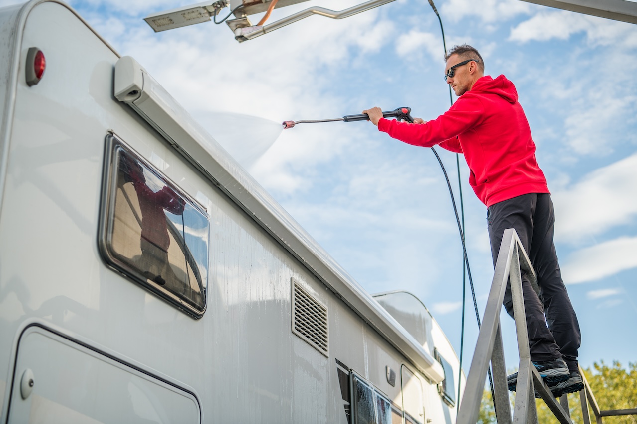 man washing rv